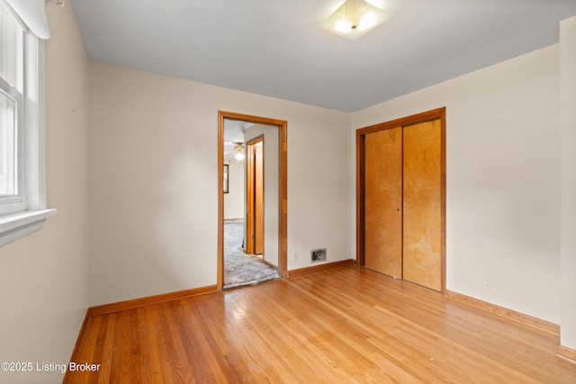 8703 Fernview Dr, Louisville, KY 40291 - unfurnished bedroom with light wood-style flooring and a closet