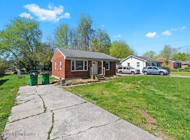 3116 Wilkie Rd, Louisville, KY 40216 - view of front of home featuring a front yard, brick siding, and driveway