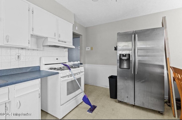 3116 Wilkie Rd, Louisville, KY 40216 - kitchen featuring white range with gas stovetop, stainless steel refrigerator with ice dispenser, white cabinets, light flooring, and under cabinet range hood