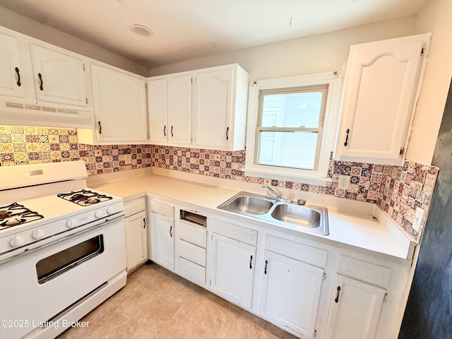 5123 Reed Ave, Louisville, KY 40214 - kitchen featuring white gas range oven, under cabinet range hood, white cabinets, light countertops, and tasteful backsplash