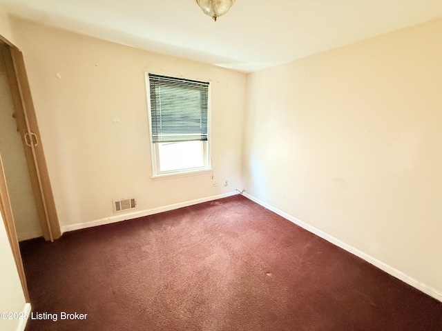 5123 Reed Ave, Louisville, KY 40214 - empty room with baseboards and dark colored carpet