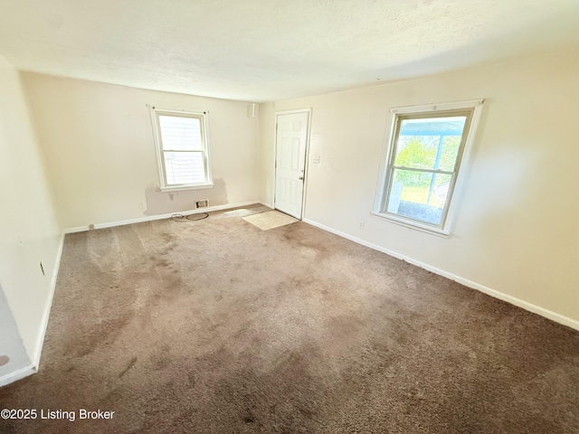 5123 Reed Ave, Louisville, KY 40214 - carpeted empty room with baseboards and a textured ceiling