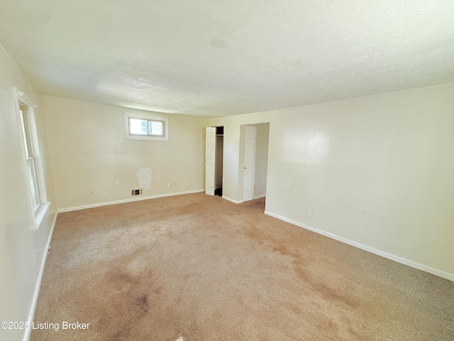 5123 Reed Ave, Louisville, KY 40214 - empty room with a textured ceiling and light colored carpet
