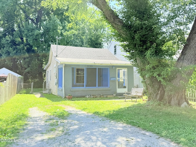 5123 Reed Ave, Louisville, KY 40214 - bungalow-style home featuring driveway, a shingled roof, and brick siding