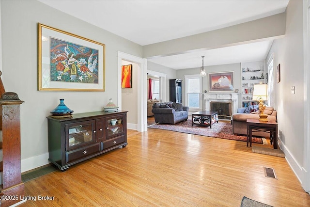 2449 Ransdell Ave, Louisville, KY 40204 - living room with light wood finished floors and a fireplace