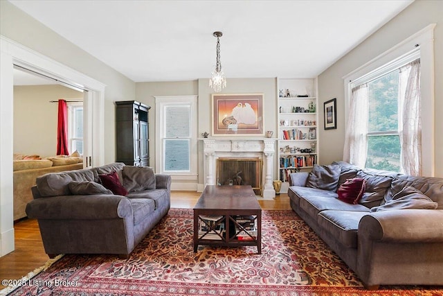 2449 Ransdell Ave, Louisville, KY 40204 - living area with wood finished floors, a premium fireplace, and built in features
