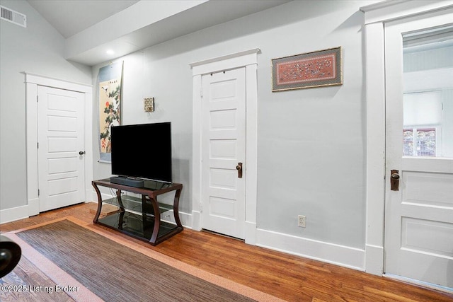 2449 Ransdell Ave, Louisville, KY 40204 - living room featuring wood finished floors, vaulted ceiling, and recessed lighting