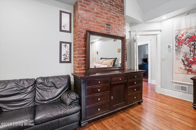 2449 Ransdell Ave, Louisville, KY 40204 - sitting room with wood finished floors and lofted ceiling