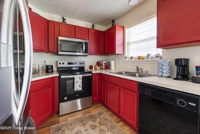 6716 Arbor Creek Dr, Louisville, KY 40228 - kitchen featuring appliances with stainless steel finishes, light wood finished floors, dark brown cabinets, light countertops, and a textured ceiling