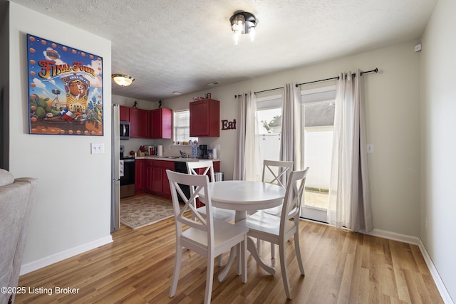 6716 Arbor Creek Dr, Louisville, KY 40228 - dining space featuring light wood finished floors and a textured ceiling
