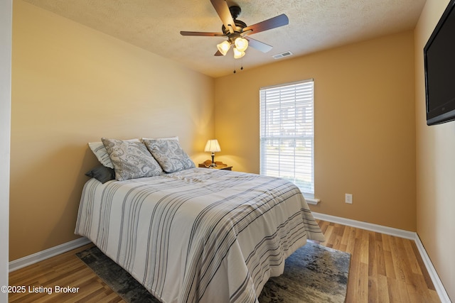 6716 Arbor Creek Dr, Louisville, KY 40228 - bedroom featuring light wood finished floors, a textured ceiling, and a ceiling fan