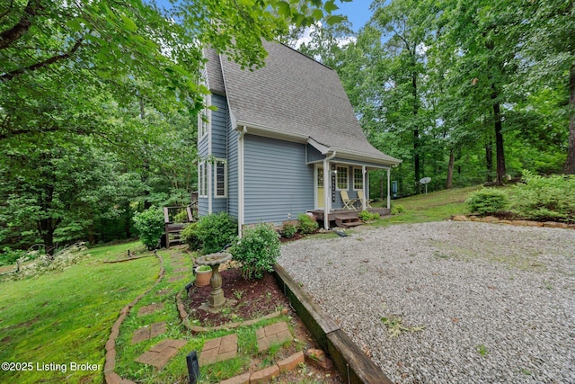 171 Cedar Point Rd, Bee Spring, KY 42207 - view of property exterior with roof with shingles, a yard, and covered porch