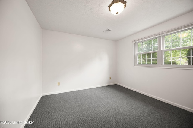 547 Wyandot Ct, Radcliff, KY 40160 - empty room featuring dark carpet and a textured ceiling
