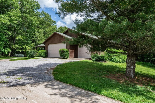 1974 N Grandview Church Rd, Cecilia, KY 42724 - view of front of property featuring gravel driveway, a front lawn, and an attached garage