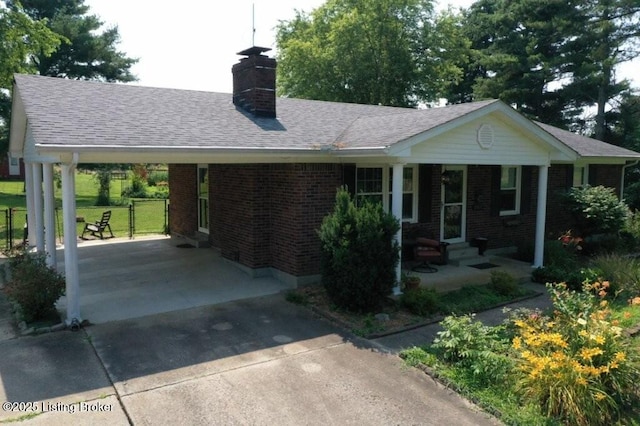 1001 Caney Fork Rd, Bardstown, KY 40004 - ranch-style house with concrete driveway, a chimney, an attached carport, and brick siding