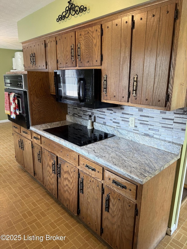 1001 Caney Fork Rd, Bardstown, KY 40004 - kitchen with black appliances, brick patterned flooring, decorative backsplash, light countertops, and brown cabinets