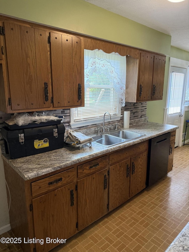 1001 Caney Fork Rd, Bardstown, KY 40004 - kitchen with dishwashing machine, brick patterned floors, tasteful backsplash, light countertops, and brown cabinetry