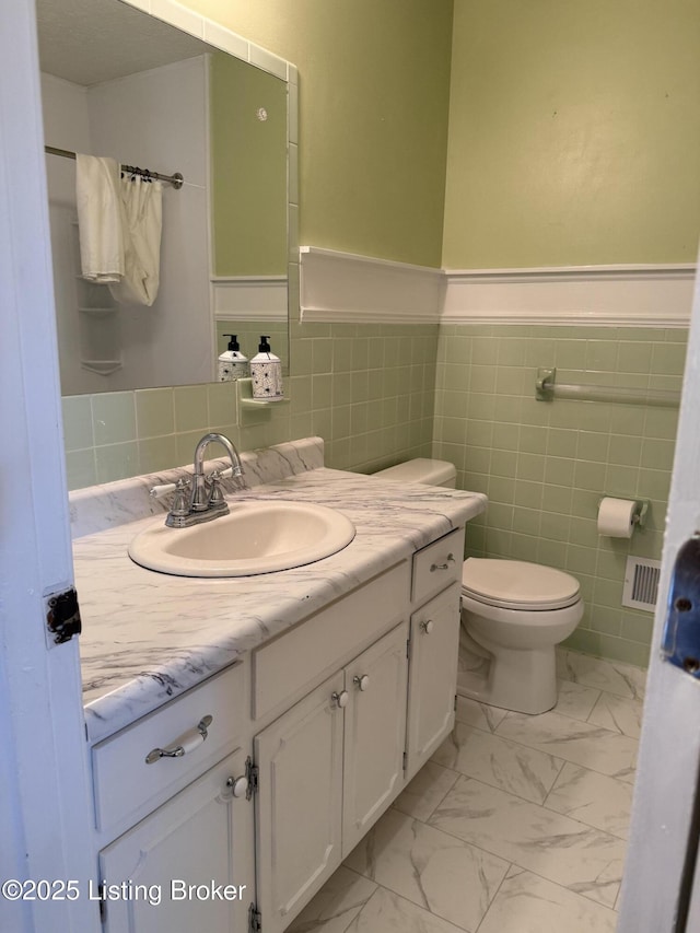 1001 Caney Fork Rd, Bardstown, KY 40004 - bathroom with vanity, marble look tile flooring, wainscoting, and tile walls