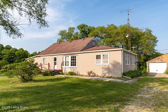 4883 S Reeves Rd, Scottsburg, IN 47170 - rear view of house featuring a lawn, an outbuilding, and a garage