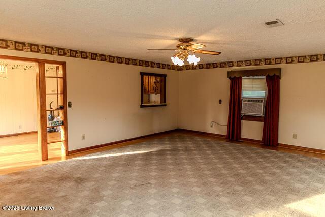 4883 S Reeves Rd, Scottsburg, IN 47170 - spare room featuring ceiling fan, cooling unit, and a textured ceiling