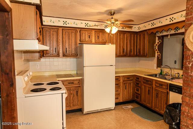 4883 S Reeves Rd, Scottsburg, IN 47170 - kitchen featuring white appliances, under cabinet range hood, ceiling fan, tasteful backsplash, and brown cabinets