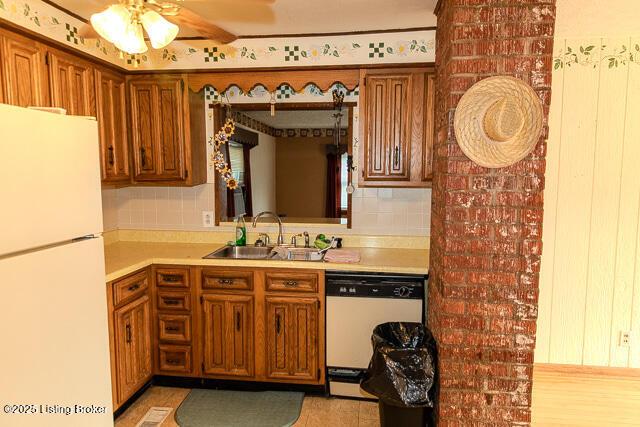 4883 S Reeves Rd, Scottsburg, IN 47170 - kitchen featuring white appliances, brown cabinets, light countertops, ceiling fan, and tasteful backsplash