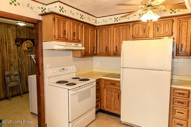4883 S Reeves Rd, Scottsburg, IN 47170 - kitchen with white appliances, under cabinet range hood, light countertops, brown cabinets, and ceiling fan
