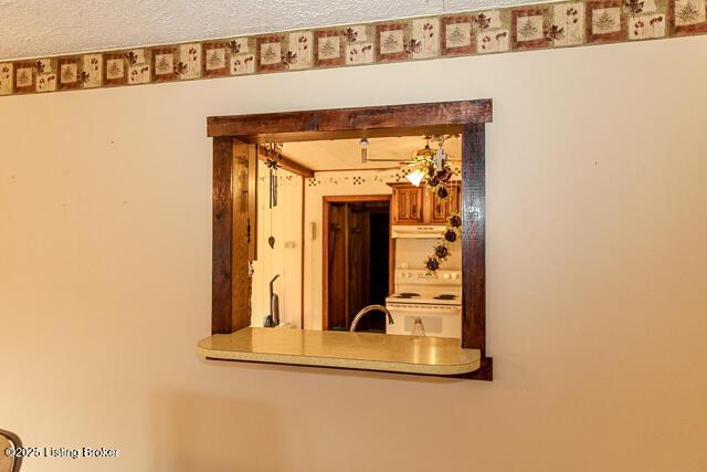 4883 S Reeves Rd, Scottsburg, IN 47170 - detailed view of white electric range and under cabinet range hood
