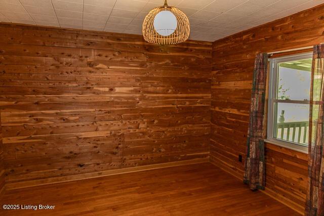 4883 S Reeves Rd, Scottsburg, IN 47170 - empty room featuring wood finished floors and wooden walls