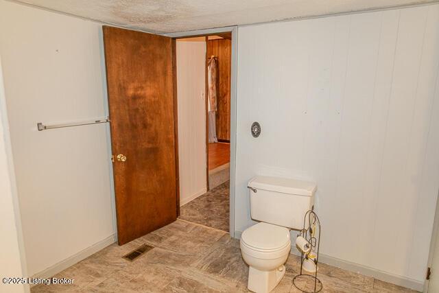 4883 S Reeves Rd, Scottsburg, IN 47170 - bathroom with toilet and baseboards