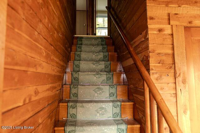 4883 S Reeves Rd, Scottsburg, IN 47170 - staircase with wooden walls