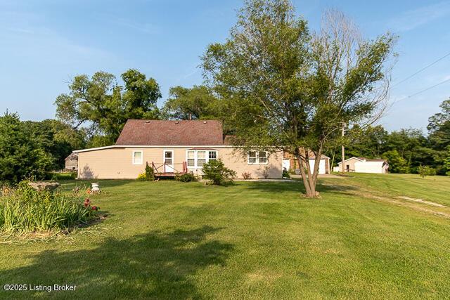 4883 S Reeves Rd, Scottsburg, IN 47170 - back of house with a lawn, a deck, and a garage