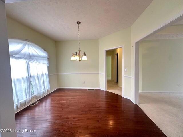 8 San Juan Ct, Elizabethtown, KY 42701 - empty room with a chandelier, wood-type flooring, and a textured ceiling
