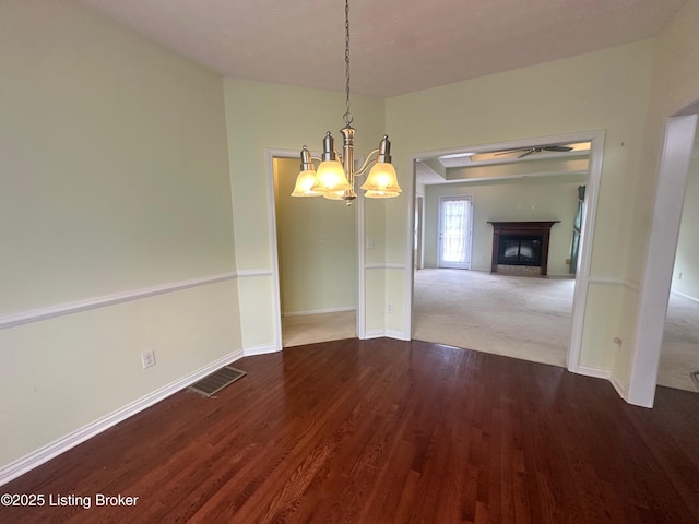 8 San Juan Ct, Elizabethtown, KY 42701 - unfurnished dining area with a chandelier, wood finished floors, a glass covered fireplace, and a ceiling fan