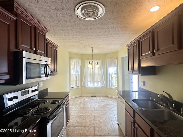 8 San Juan Ct, Elizabethtown, KY 42701 - kitchen featuring appliances with stainless steel finishes, a chandelier, dark countertops, pendant lighting, and dark brown cabinets