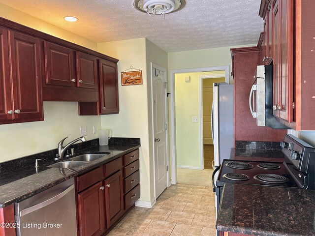 8 San Juan Ct, Elizabethtown, KY 42701 - kitchen with appliances with stainless steel finishes, dark brown cabinets, dark stone counters, a textured ceiling, and recessed lighting