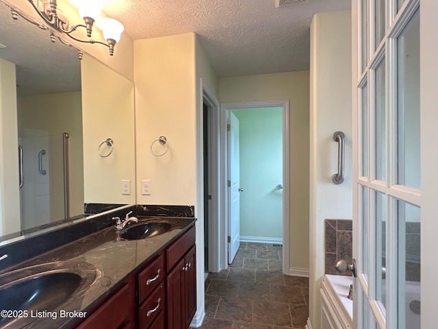 8 San Juan Ct, Elizabethtown, KY 42701 - bathroom featuring double vanity, a bath, a textured ceiling, a shower with door, and stone finish floors
