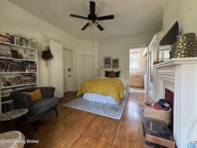 416 Belgravia Ct, Louisville, KY 40208 - bedroom featuring wood finished floors, a fireplace, ensuite bathroom, and ceiling fan