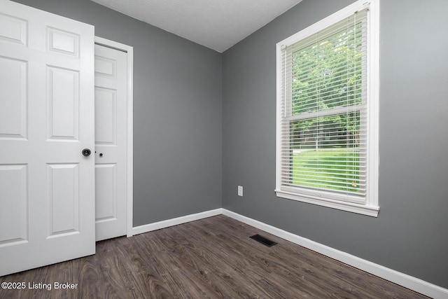 1008 E Mailback Way, Crestwood, KY 40014 - unfurnished bedroom with multiple windows, dark wood finished floors, and a textured ceiling