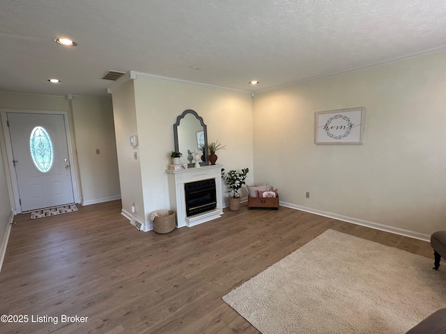 64 Probus Rd, Leitchfield, KY 42754 - living room with crown molding, wood finished floors, recessed lighting, and a glass covered fireplace