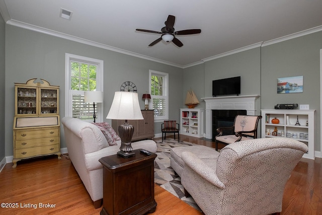 9508 Norton Commons Blvd Unit 102, Prospect, KY 40059 - living room featuring crown molding, wood finished floors, a ceiling fan, and a tiled fireplace