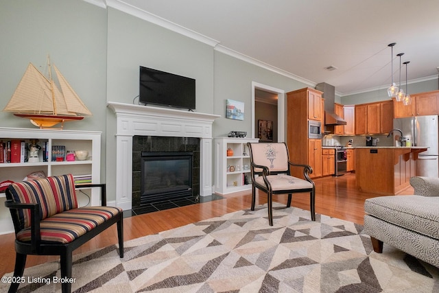 9508 Norton Commons Blvd Unit 102, Prospect, KY 40059 - living area featuring light wood-style flooring, ornamental molding, and a fireplace