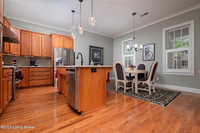 9508 Norton Commons Blvd Unit 102, Prospect, KY 40059 - kitchen featuring appliances with stainless steel finishes, wall chimney range hood, crown molding, light wood-style flooring, and decorative backsplash