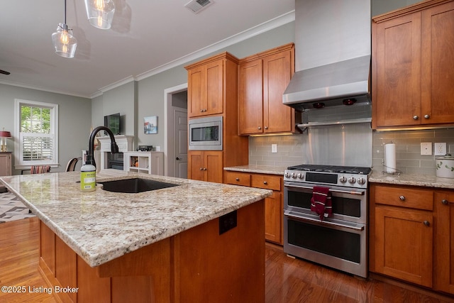 9508 Norton Commons Blvd Unit 102, Prospect, KY 40059 - kitchen with appliances with stainless steel finishes, wood finished floors, wall chimney exhaust hood, brown cabinetry, and crown molding