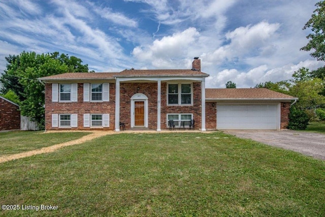 825 Crocus Dr, Radcliff, KY 40160 - raised ranch with asphalt driveway, a chimney, a garage, a front lawn, and brick siding