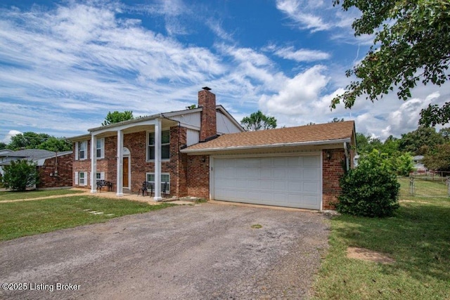 825 Crocus Dr, Radcliff, KY 40160 - view of front of property featuring driveway, a chimney, brick siding, and a garage