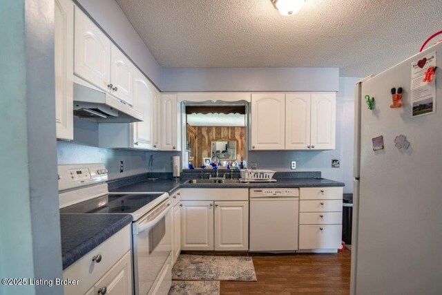 825 Crocus Dr, Radcliff, KY 40160 - kitchen featuring white appliances, under cabinet range hood, dark countertops, dark wood finished floors, and a textured ceiling