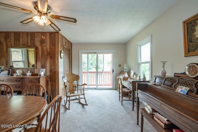 825 Crocus Dr, Radcliff, KY 40160 - dining area with light colored carpet, ceiling fan, a textured ceiling, and wood walls