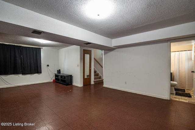 825 Crocus Dr, Radcliff, KY 40160 - finished below grade area featuring a textured ceiling, stairs, and tile patterned floors