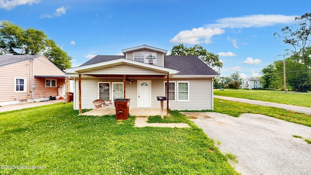 1117 6th St, Carrollton, KY 41008 - bungalow-style home with a patio area, a front lawn, a ceiling fan, and a shingled roof